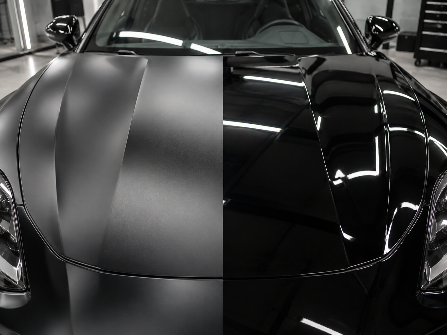 Black sports car hood split between satin matte and high gloss paint protection film