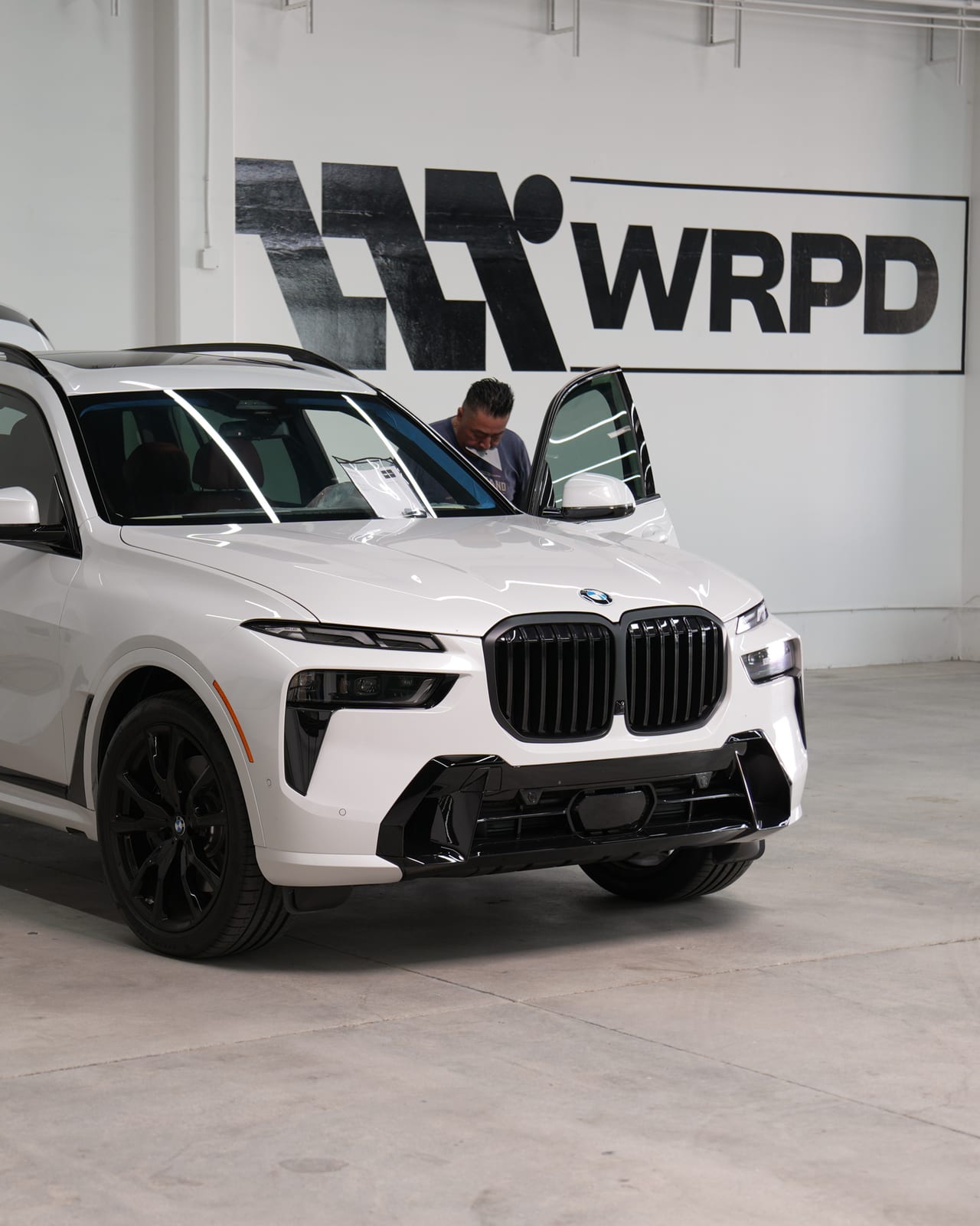 White BMW X7 with fresh window tint inside the WRPD studio in Chatsworth