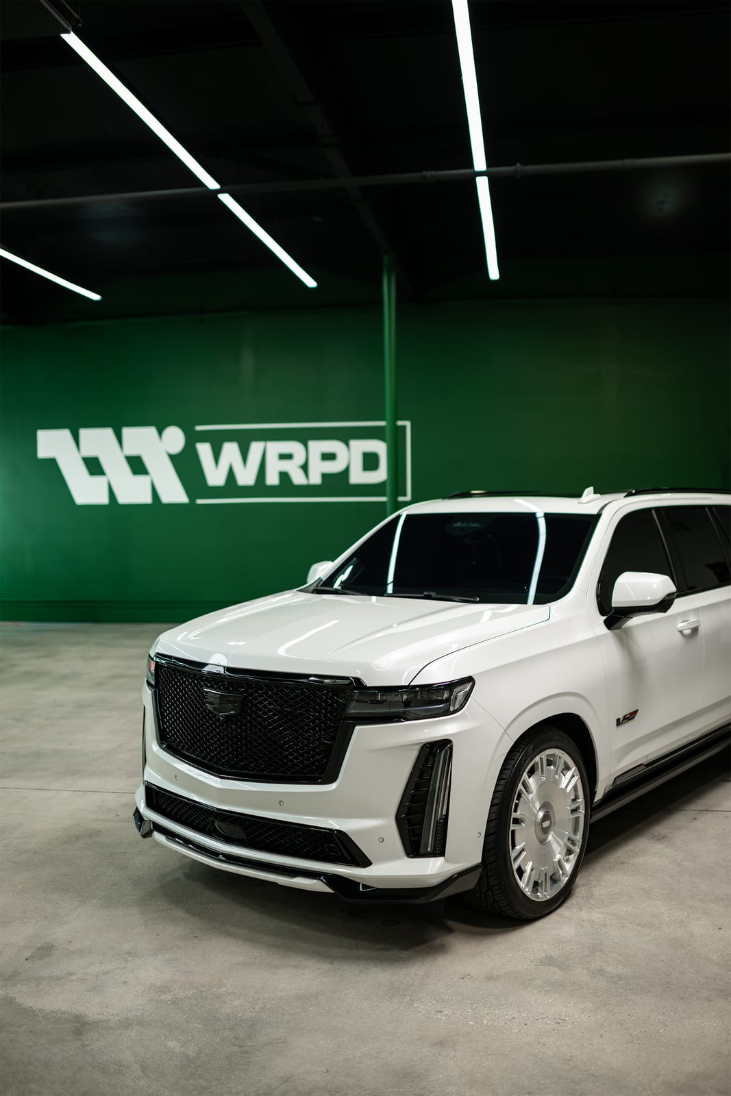 Glossy white Cadillac Escalade front three quarter view after protection work at WRPD