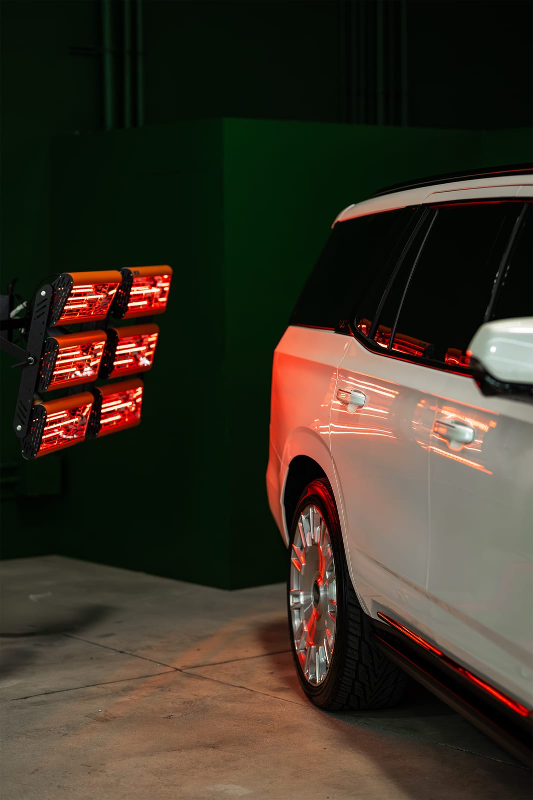 White Cadillac Escalade curing under infrared lamps after ceramic coating at WRPD in Chatsworth