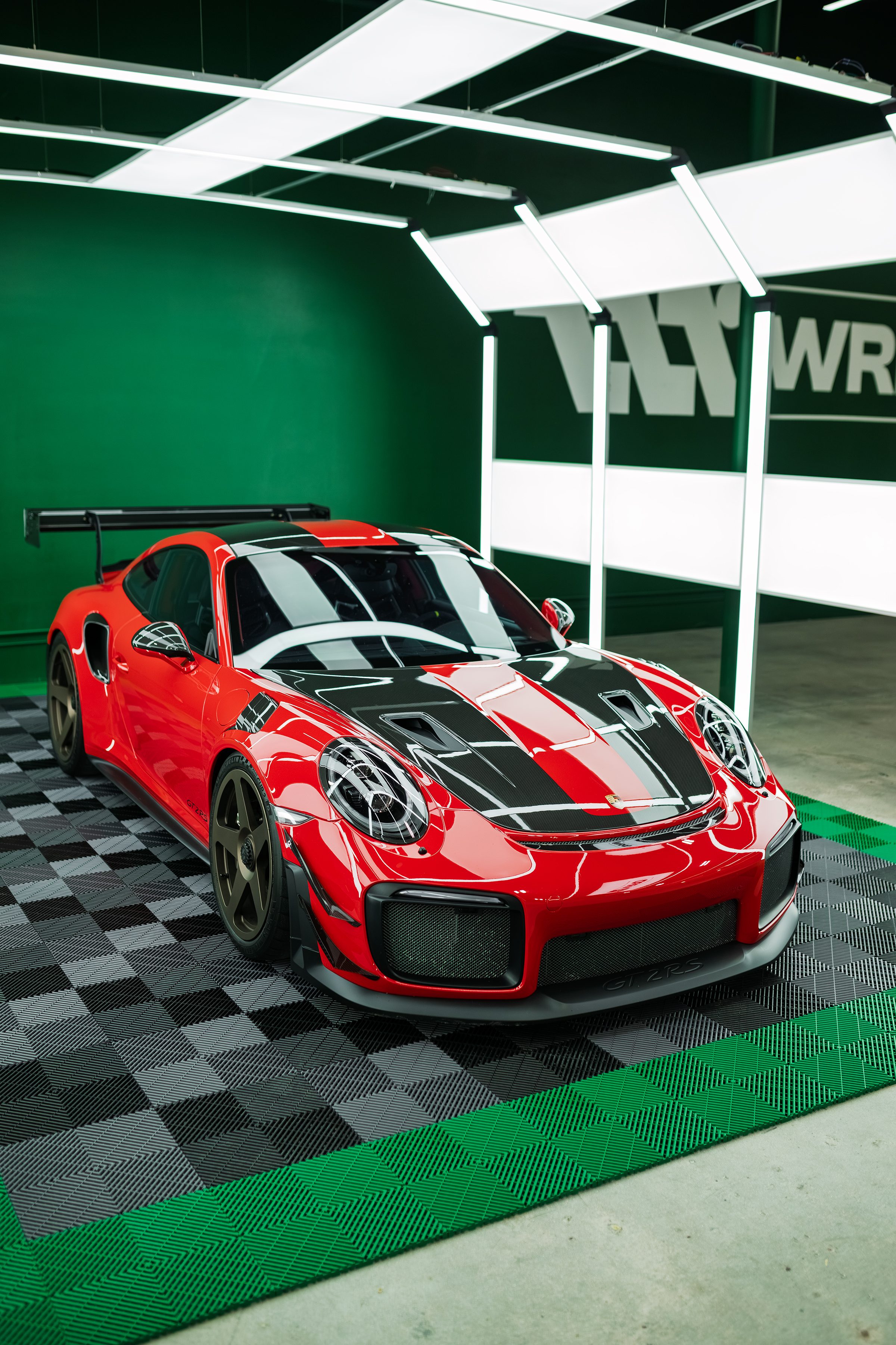 Red Porsche 911 GT2 RS with carbon racing stripes in the WRPD studio